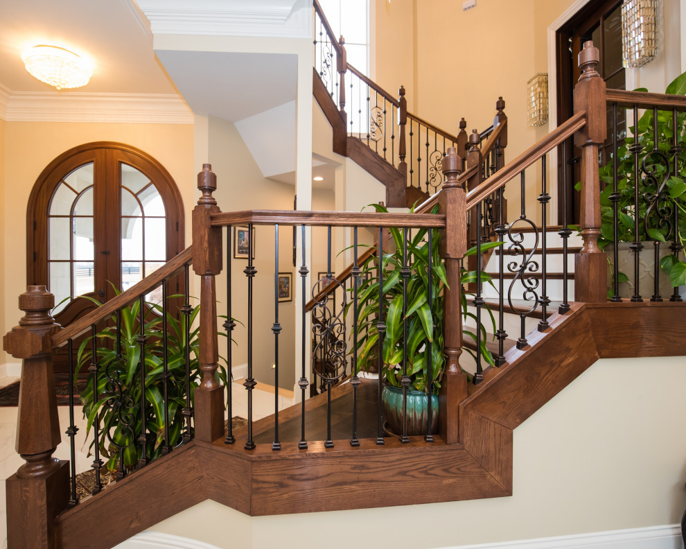 Inspiration for a wood staircase with wood risers and metal railing.
