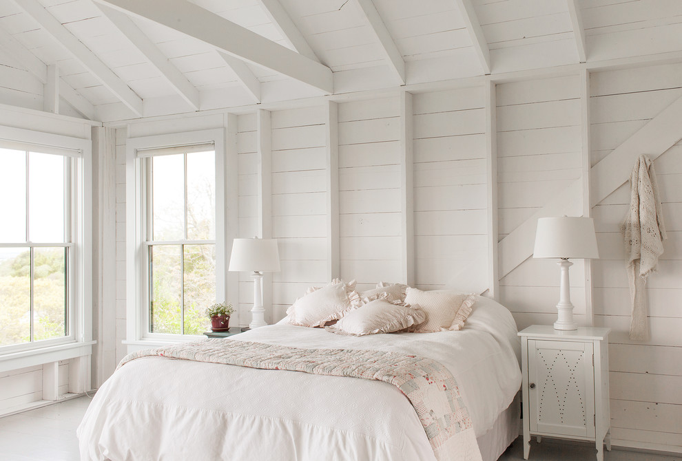 Inspiration for a beach style bedroom in New York with white walls, painted wood floors and white floor.