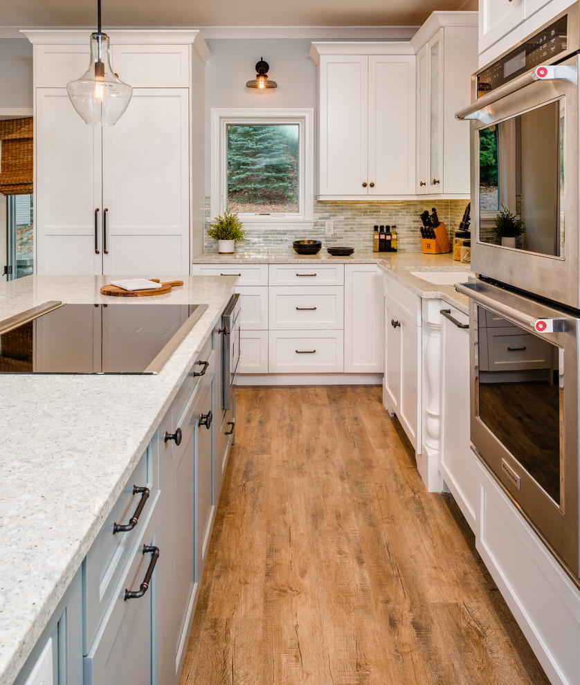 Inspiration for a mid-sized transitional medium tone wood floor and multicolored floor eat-in kitchen remodel with an undermount sink, shaker cabinets, gray cabinets, quartz countertops, blue backsplash, mosaic tile backsplash, stainless steel appliances, an island and multicolored countertops