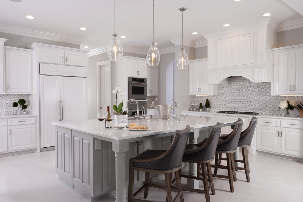 Inspiration for an expansive traditional kitchen in Atlanta with raised-panel cabinets, white cabinets, with island, white floor, white benchtop, multi-coloured splashback, panelled appliances, marble benchtops and marble splashback.