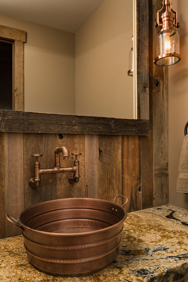 Example of a small mountain style medium tone wood floor and brown floor powder room design with brown walls, a vessel sink, granite countertops and beige countertops