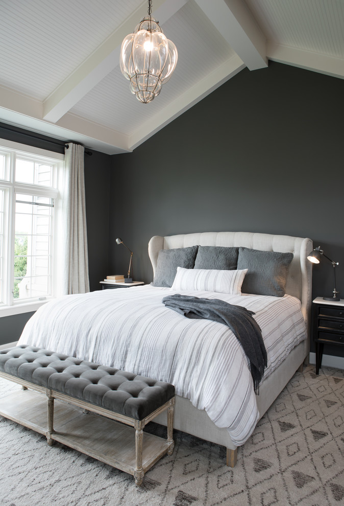 Transitional bedroom in Other with grey walls and grey floor.