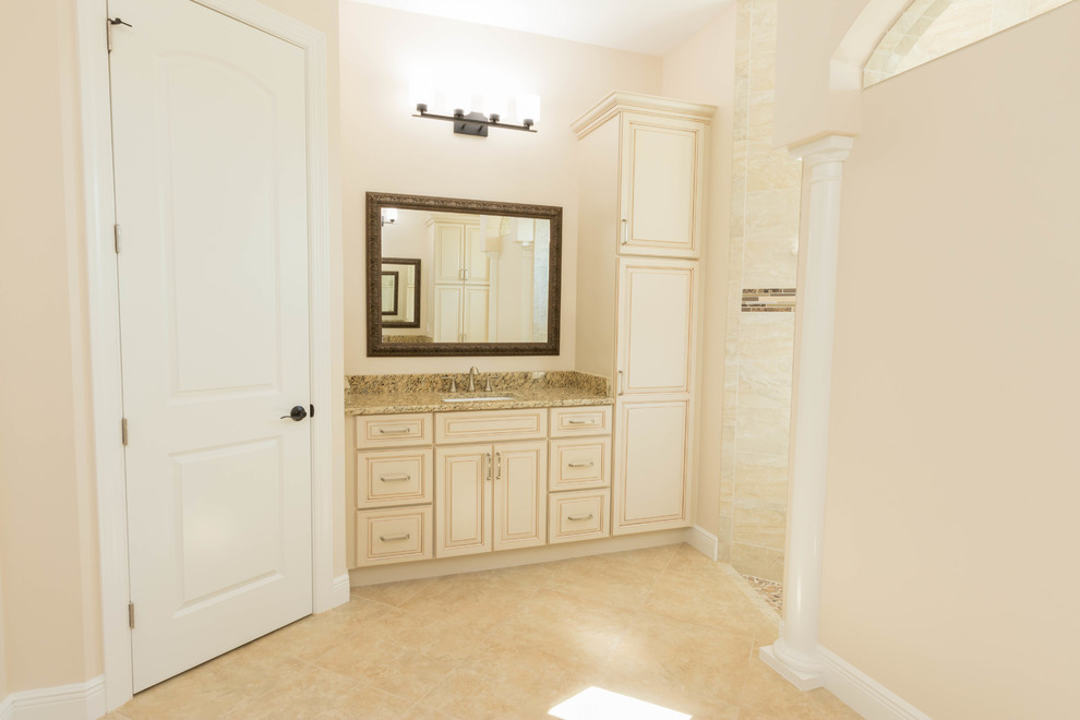 Small traditional master bathroom in Miami with furniture-like cabinets, beige cabinets, a one-piece toilet, beige tile, porcelain tile, beige walls, porcelain floors, an undermount sink, granite benchtops and an open shower.