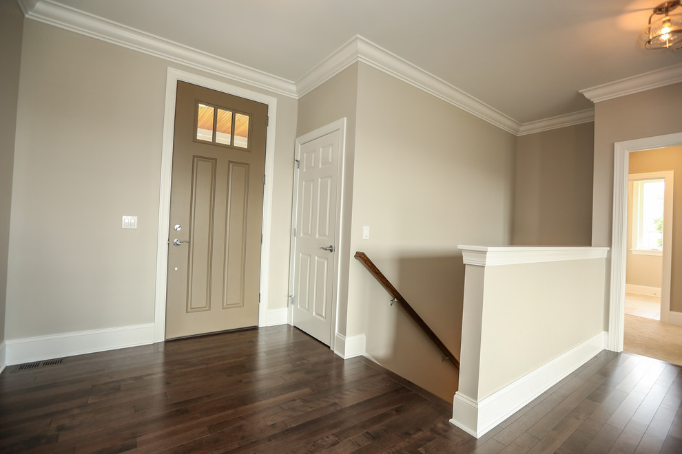 This is an example of a mid-sized transitional wood straight staircase in New York with wood risers and wood railing.
