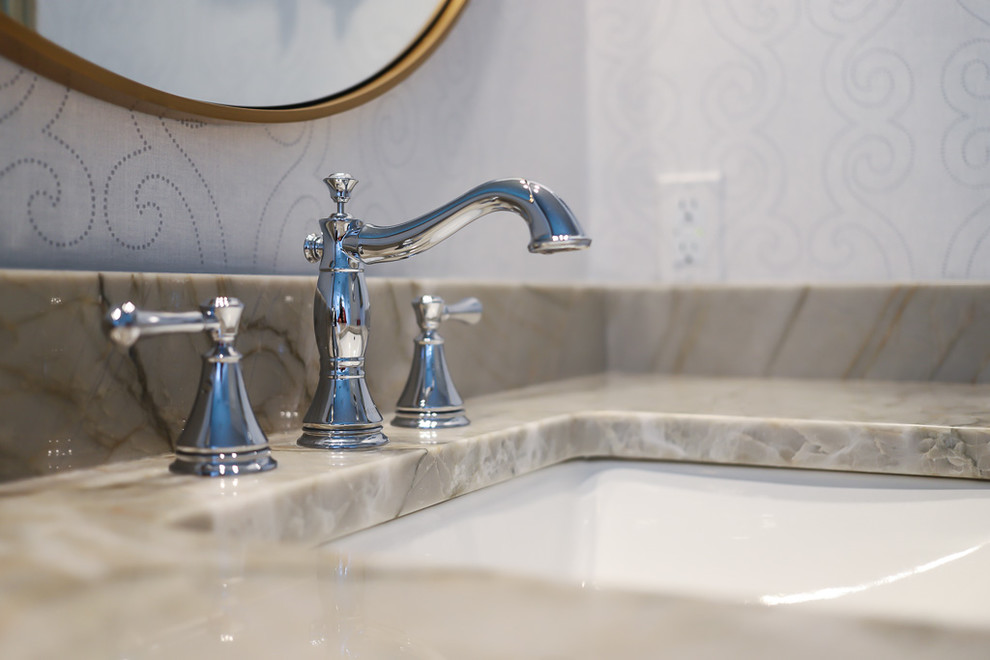 Example of a mid-sized transitional master white tile and marble tile ceramic tile and gray floor alcove bathtub design with gray walls, beaded inset cabinets, white cabinets, a two-piece toilet, an undermount sink, quartzite countertops and a hinged shower door