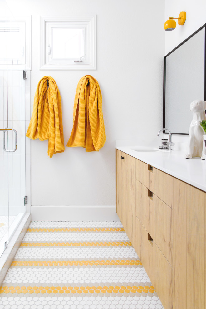 This is an example of a contemporary grey and yellow bathroom in San Diego with flat-panel cabinets, light wood cabinets, an alcove shower, white tiles, white walls, a submerged sink, yellow floors, a hinged door, white worktops, double sinks and a built in vanity unit.