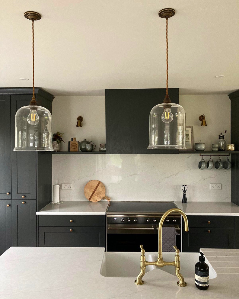 Design ideas for a mid-sized contemporary single-wall open plan kitchen in Other with a farmhouse sink, shaker cabinets, grey cabinets, quartzite benchtops, white splashback, engineered quartz splashback, panelled appliances, laminate floors, with island, beige floor and white benchtop.