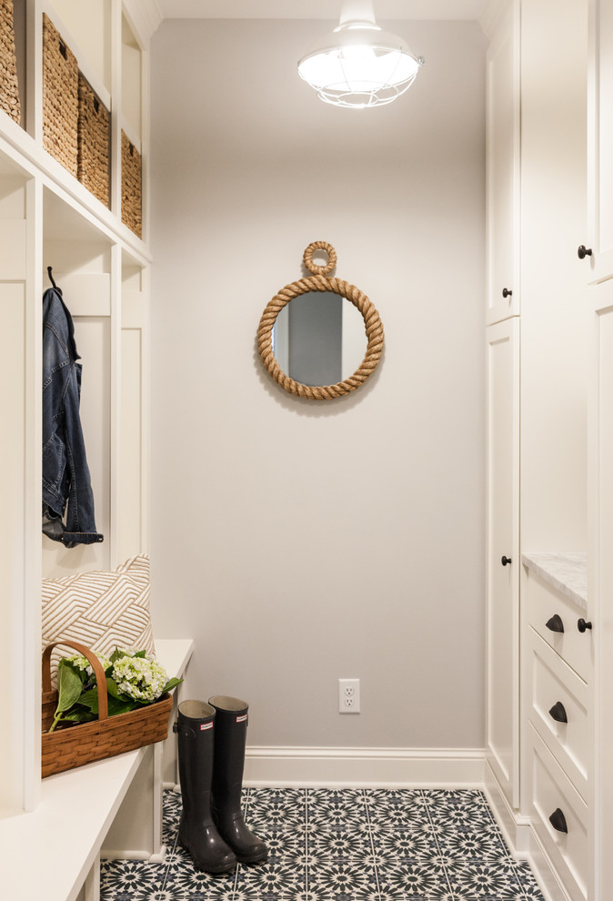 Inspiration for a mid-sized beach style mudroom in Minneapolis with grey walls and blue floor.