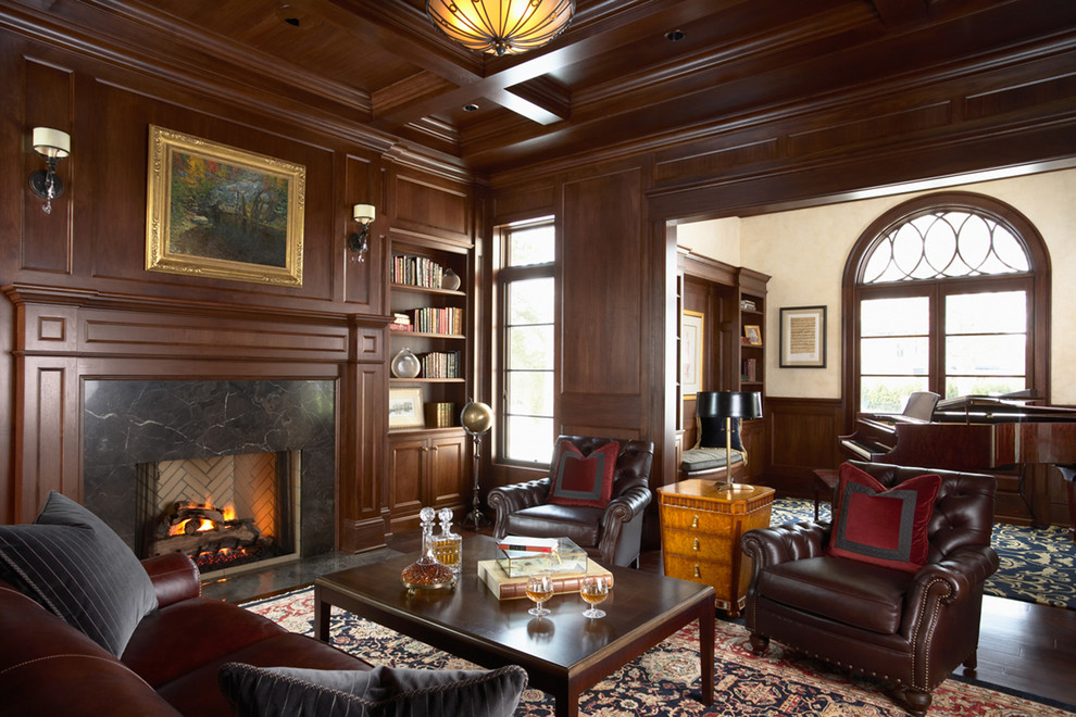 Photo of a traditional home office in Minneapolis with white walls, dark hardwood floors, a standard fireplace and a stone fireplace surround.