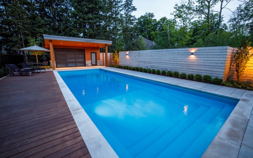 Modern swimming pool in Toronto with brick paving.