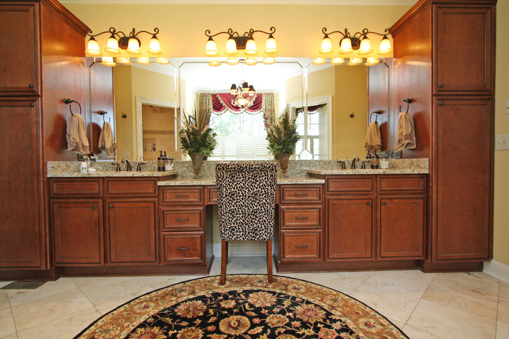 Large traditional master bathroom in Atlanta with recessed-panel cabinets, dark wood cabinets, a drop-in tub, a corner shower, a two-piece toilet, beige tile, travertine, yellow walls, porcelain floors, an undermount sink, granite benchtops, beige floor, an open shower and multi-coloured benchtops.