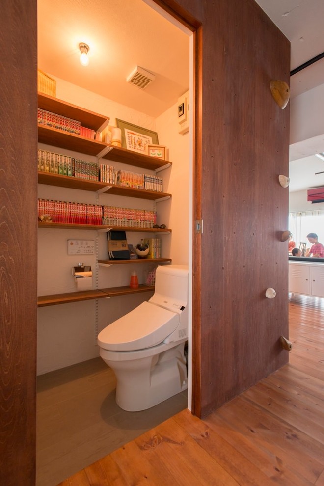 東京23区にあるカントリー風のおしゃれなトイレ・洗面所 (白い壁、コンクリートの床、グレーの床) の写真