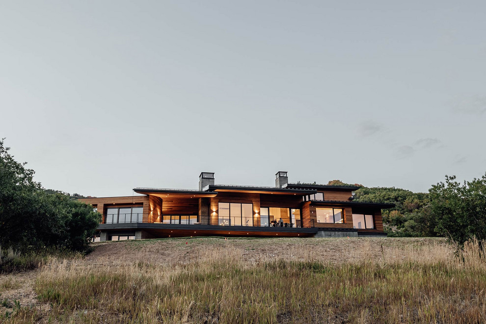 Inspiration for a large contemporary two-storey multi-coloured house exterior in Salt Lake City with mixed siding, a flat roof and a green roof.