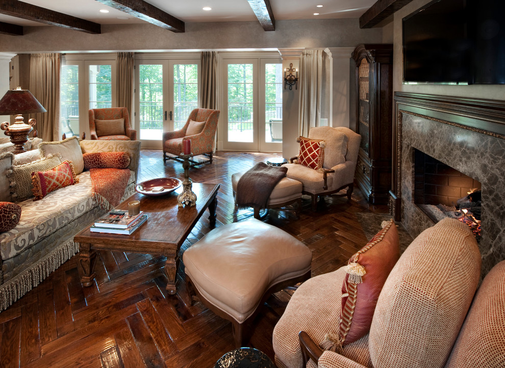 Design ideas for an expansive traditional open concept family room in DC Metro with grey walls, dark hardwood floors, a standard fireplace, a tile fireplace surround, a wall-mounted tv and brown floor.
