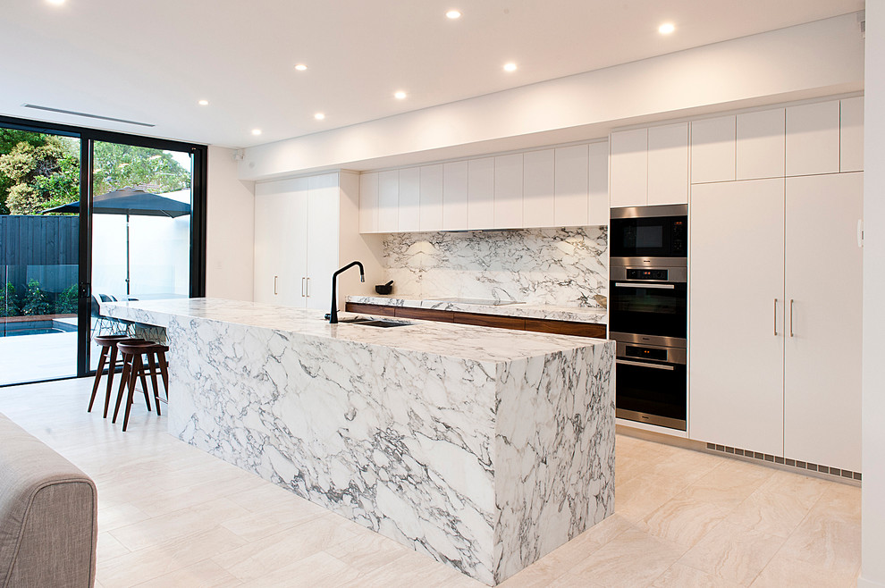Design ideas for a large contemporary galley eat-in kitchen in Perth with a double-bowl sink, flat-panel cabinets, dark wood cabinets, marble benchtops, white splashback, stone slab splashback, stainless steel appliances, porcelain floors and with island.
