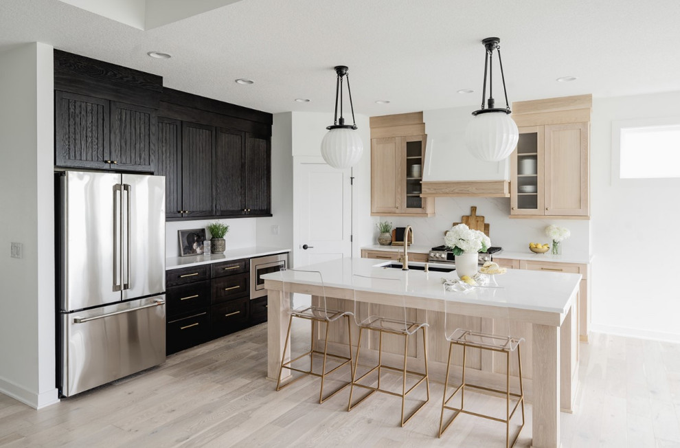 Inspiration for a mid-sized modern l-shaped open plan kitchen in Other with an undermount sink, shaker cabinets, light wood cabinets, marble benchtops, white splashback, ceramic splashback, stainless steel appliances, light hardwood floors, with island, multi-coloured floor, white benchtop and vaulted.