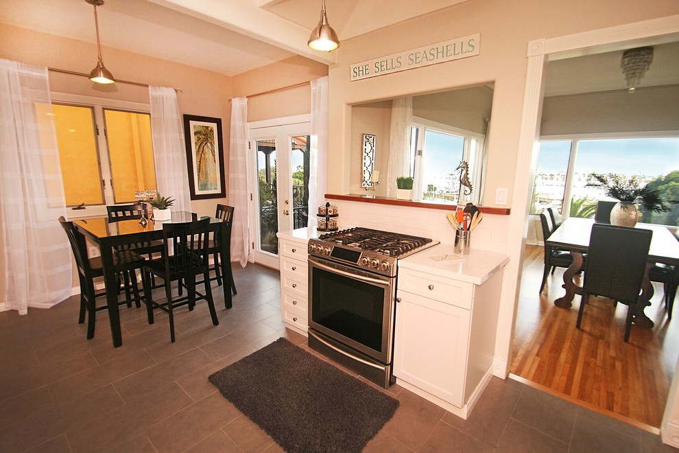 Transitional galley eat-in kitchen photo in Orange County with a single-bowl sink, shaker cabinets, white cabinets, white backsplash, subway tile backsplash and stainless steel appliances