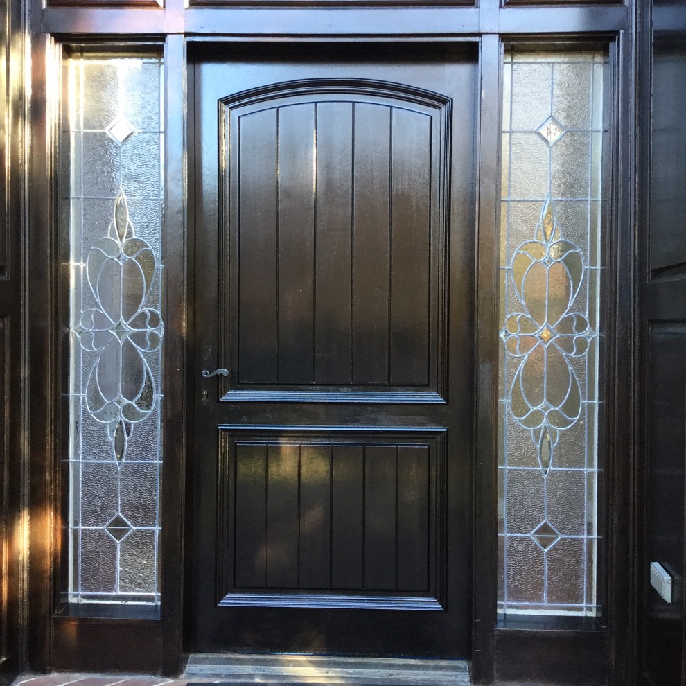 Photo of a mid-sized traditional front door in Louisville with a single front door and a black front door.