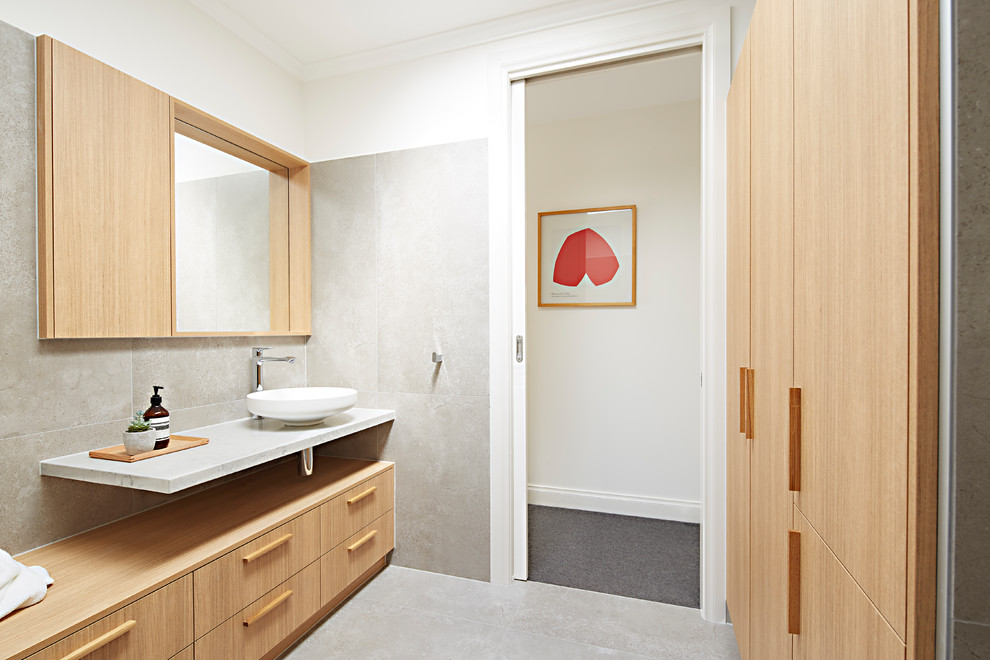 Mid-sized beach style master bathroom in Melbourne with beaded inset cabinets, light wood cabinets, an alcove shower, a wall-mount toilet, multi-coloured tile, stone slab, multi-coloured walls, a vessel sink, marble benchtops, an open shower and white benchtops.