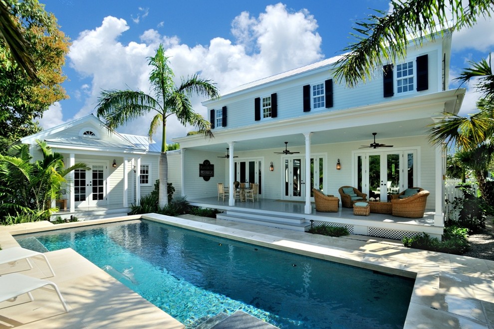 Design ideas for a tropical backyard l-shaped pool in Miami.