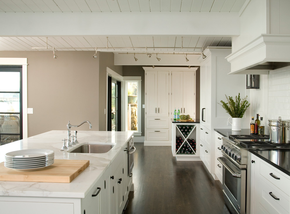 Traditional kitchen in Seattle with white cabinets and dark hardwood floors.