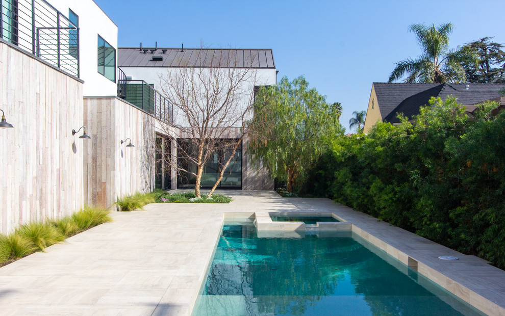 Photo of a mid-sized modern backyard rectangular pool in Los Angeles with a hot tub and concrete slab.