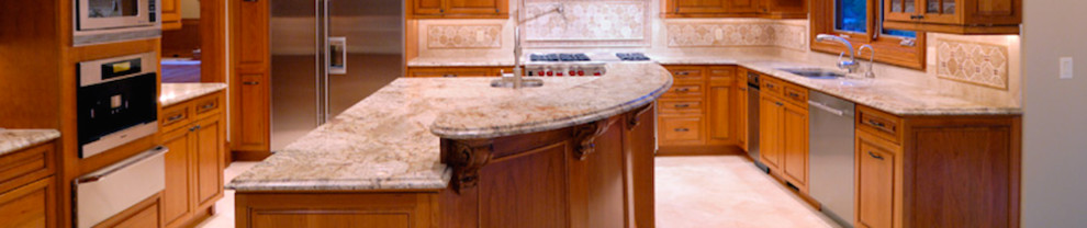 Example of a mid-sized galley enclosed kitchen design in Phoenix with an island
