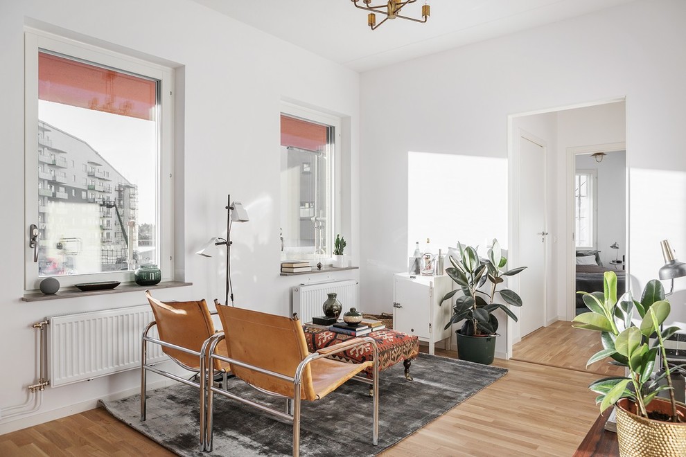 Design ideas for a mid-sized eclectic open concept living room in Stockholm with white walls.