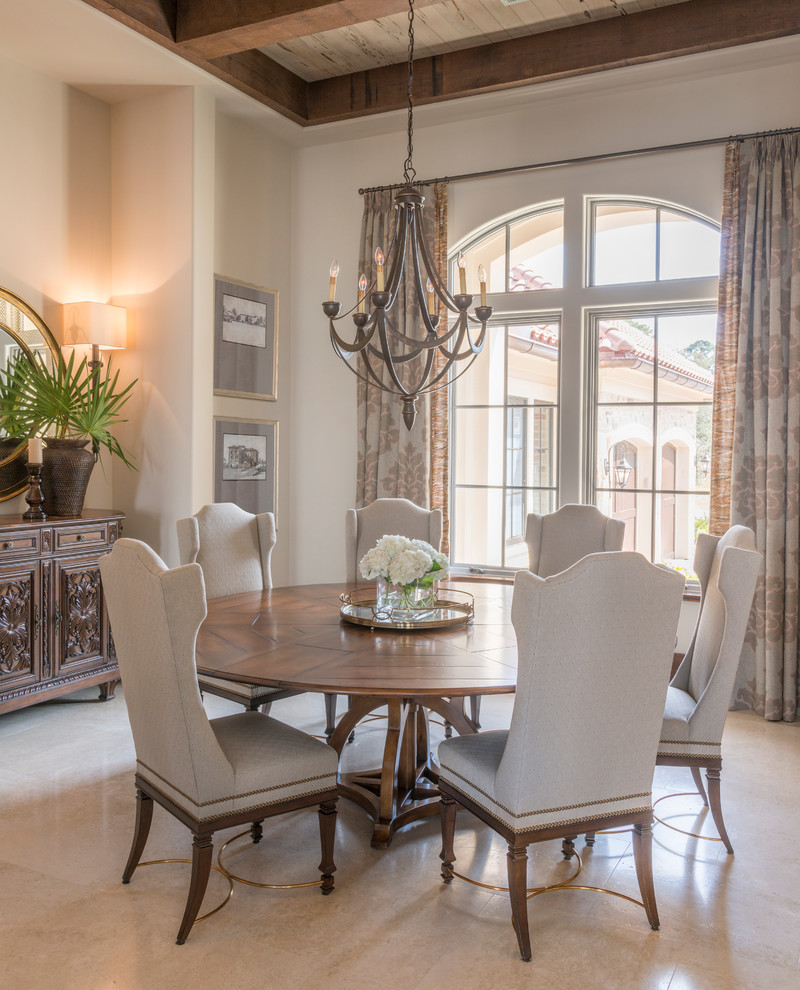 Photo of a large mediterranean separate dining room in Atlanta with white walls, no fireplace and limestone floors.