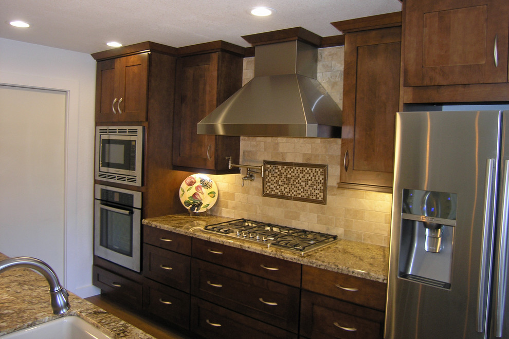 Mid-sized transitional medium tone wood floor and brown floor kitchen photo in Sacramento with an undermount sink, shaker cabinets, medium tone wood cabinets, granite countertops, beige backsplash, subway tile backsplash and stainless steel appliances