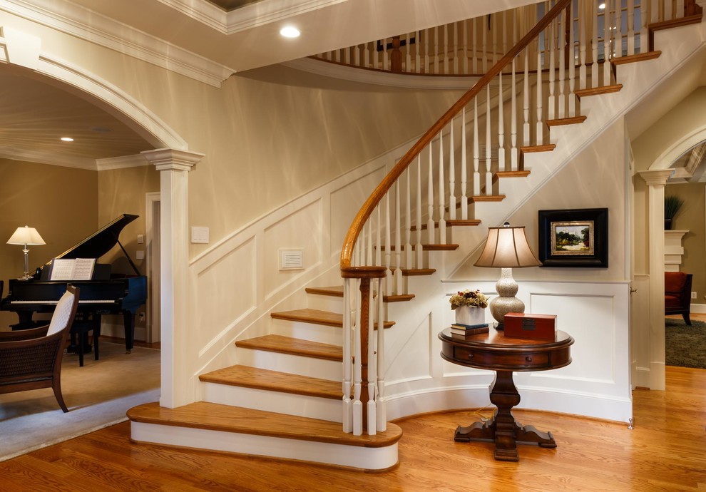 This is an example of a mid-sized traditional foyer in DC Metro with beige walls, medium hardwood floors and brown floor.