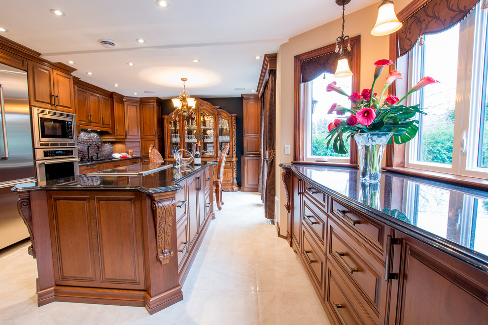 Inspiration for a large traditional u-shaped separate kitchen in Montreal with an undermount sink, raised-panel cabinets, medium wood cabinets, granite benchtops, black splashback, mosaic tile splashback, stainless steel appliances, ceramic floors and with island.