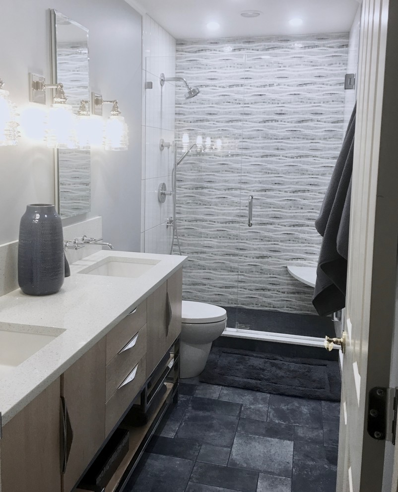 Inspiration for a mid-sized contemporary kids bathroom in Boston with flat-panel cabinets, light wood cabinets, an alcove shower, a two-piece toilet, multi-coloured tile, mosaic tile, blue walls, porcelain floors, an undermount sink, engineered quartz benchtops, blue floor, a hinged shower door and white benchtops.