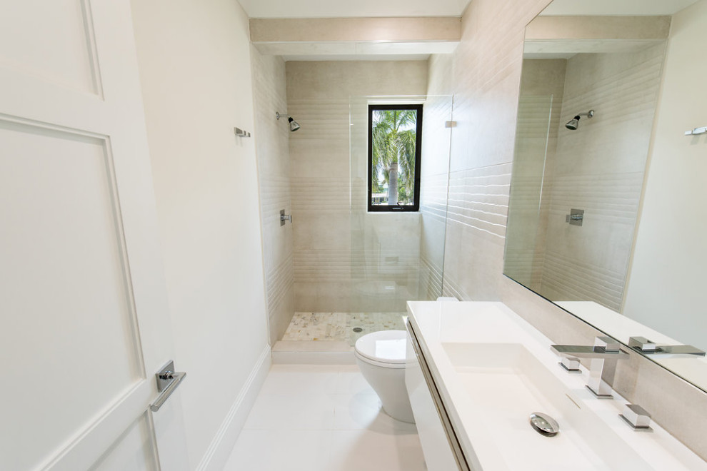 Photo of a medium sized contemporary bathroom in Miami with white cabinets, a walk-in shower, beige walls, an integrated sink, engineered stone worktops, an open shower, white worktops, a single sink, a floating vanity unit and beaded cabinets.