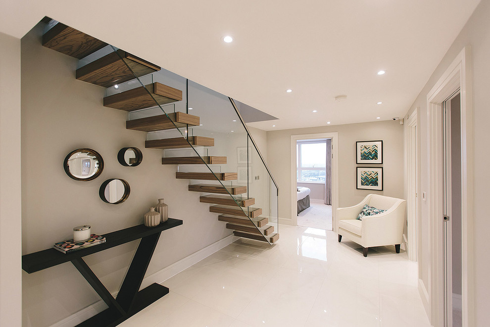 Inspiration for a large contemporary hallway in London with white walls and porcelain floors.