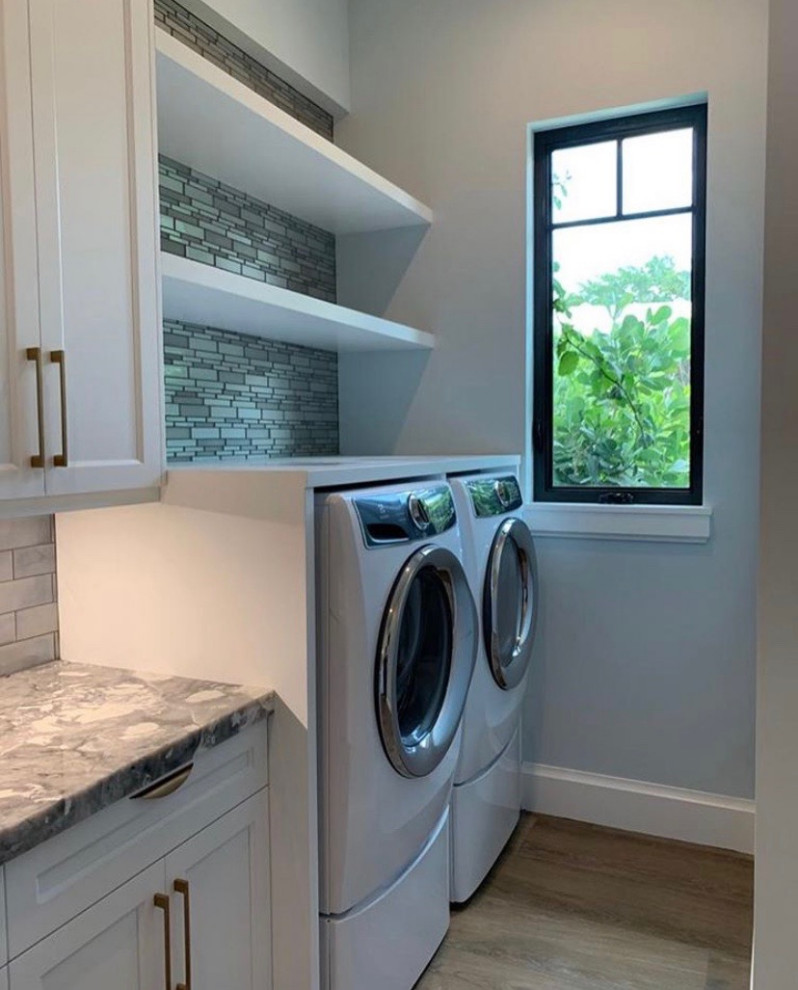 Inspiration for a mid-sized modern galley utility room in Other with a drop-in sink, white cabinets, marble benchtops, grey splashback, grey walls, painted wood floors, a side-by-side washer and dryer, multi-coloured floor and multi-coloured benchtop.