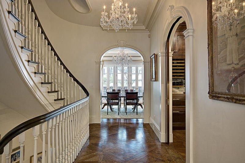 This is an example of a large traditional wood curved staircase in New York.