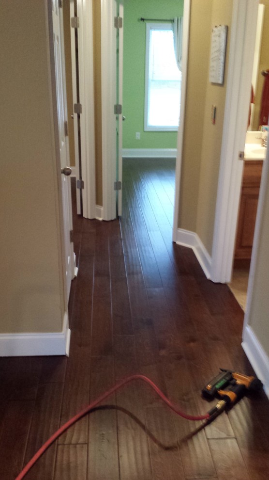 Example of a small transitional medium tone wood floor hallway design with beige walls