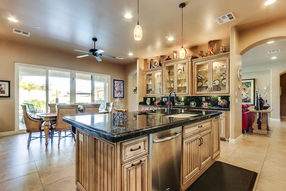 Large transitional eat-in kitchen in Phoenix with an undermount sink, beige cabinets, granite benchtops, black splashback, stone slab splashback, stainless steel appliances, cement tiles, with island, beige floor, black benchtop and recessed-panel cabinets.