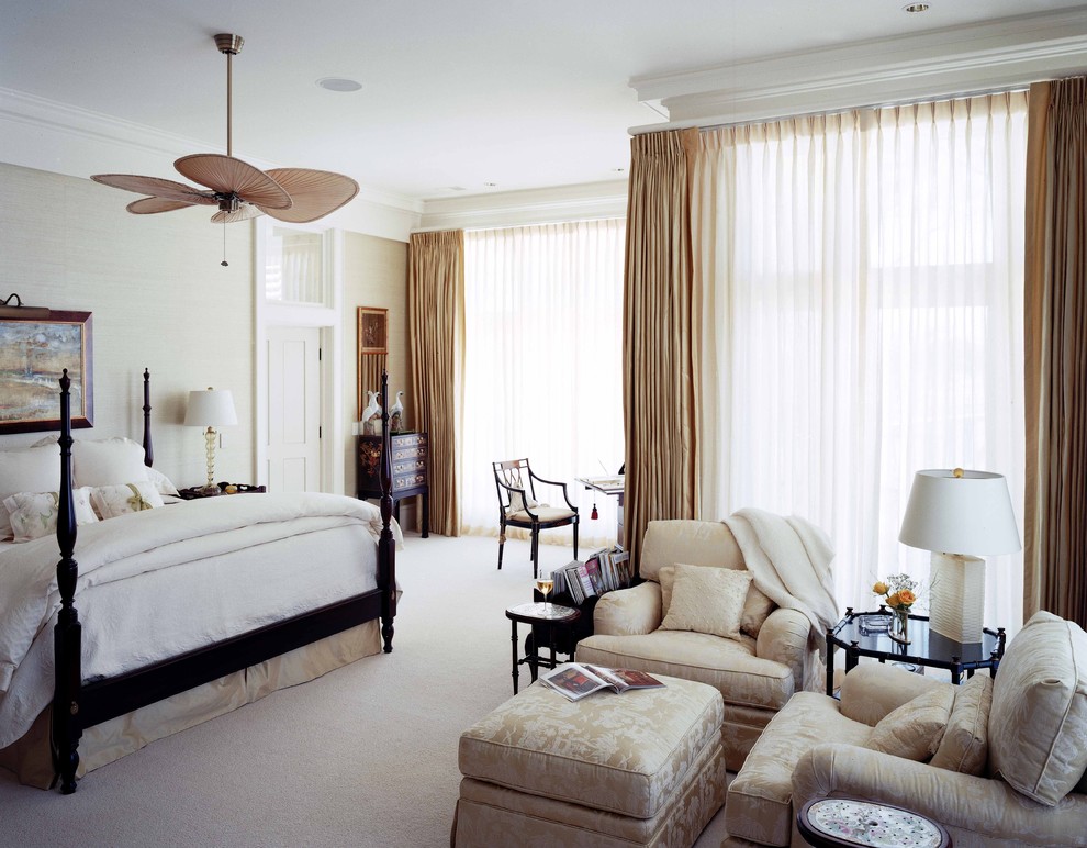 Photo of a large traditional master bedroom in Atlanta with beige walls and carpet.