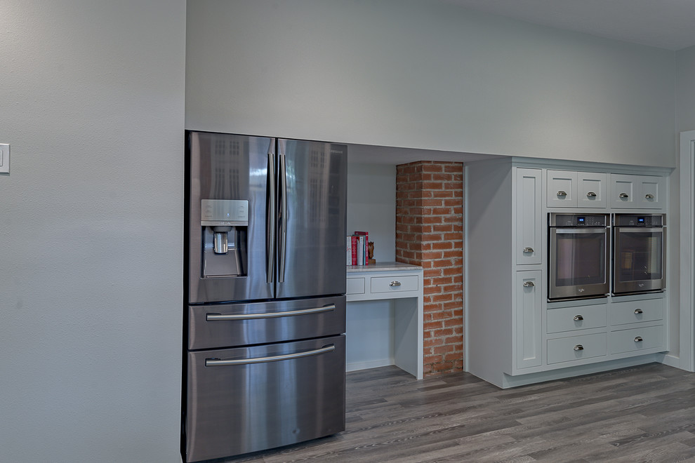 Eat-in kitchen - large rustic galley dark wood floor eat-in kitchen idea in Austin with a farmhouse sink, open cabinets, white cabinets, quartzite countertops, multicolored backsplash, marble backsplash, stainless steel appliances and no island
