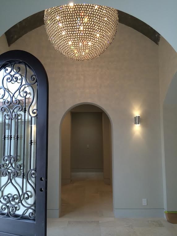 This is an example of a large transitional foyer in Santa Barbara with beige walls, a single front door and a metal front door.