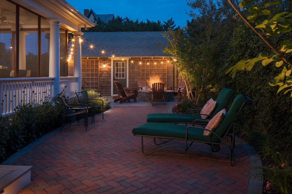 Inspiration for a mid-sized traditional backyard patio in Philadelphia with a fire feature, brick pavers and no cover.