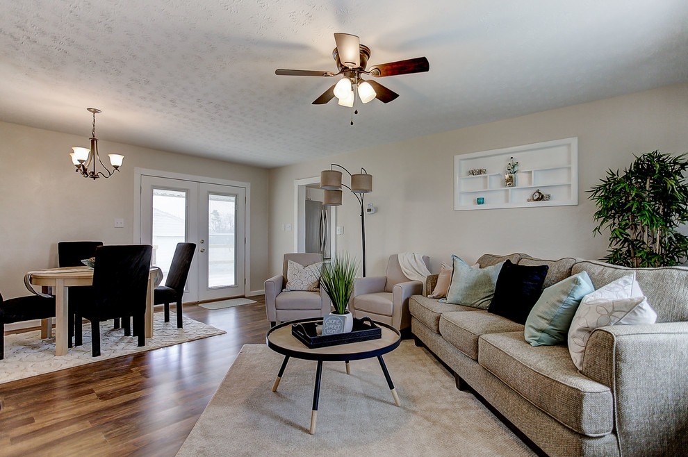 Mid-sized transitional open concept living room in Cincinnati with beige walls, medium hardwood floors, no tv and brown floor.