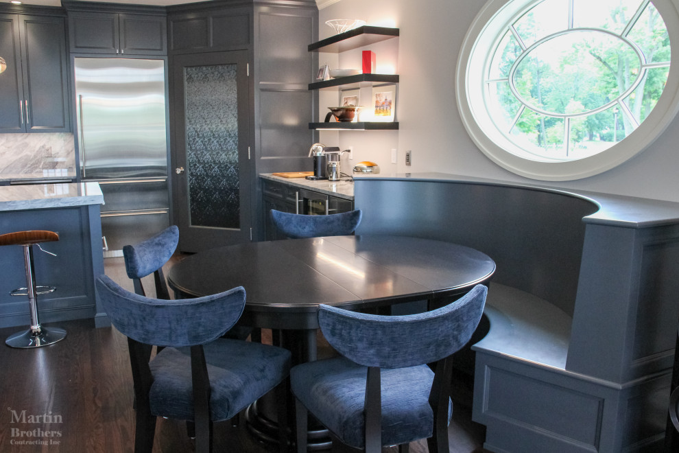 Inspiration for a large transitional single-wall medium tone wood floor open concept kitchen remodel with a double-bowl sink, recessed-panel cabinets, gray cabinets, marble countertops, multicolored backsplash, stainless steel appliances, an island and marble backsplash
