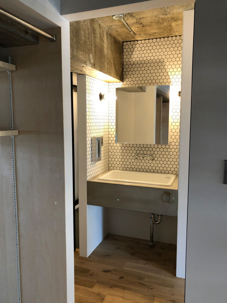 Inspiration for a small modern powder room in Other with open cabinets, grey cabinets, white tile, ceramic tile, white walls, medium hardwood floors, an undermount sink, concrete benchtops, grey benchtops, a built-in vanity and exposed beam.