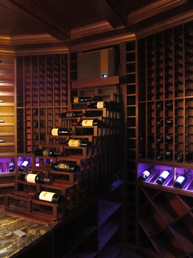 Example of a large transitional wine cellar design in Orlando with display racks