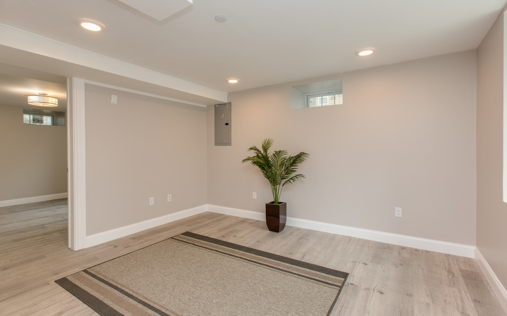 Inspiration for a mid-sized transitional home yoga studio in Boston with beige walls, light hardwood floors and beige floor.