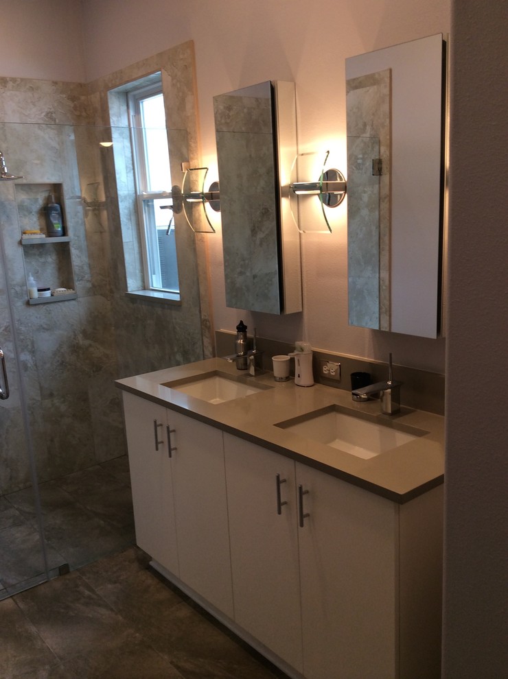 Photo of a mid-sized contemporary bathroom in Tampa with an undermount sink, flat-panel cabinets, white cabinets, engineered quartz benchtops, a curbless shower, a two-piece toilet, beige tile, porcelain tile, grey walls and porcelain floors.