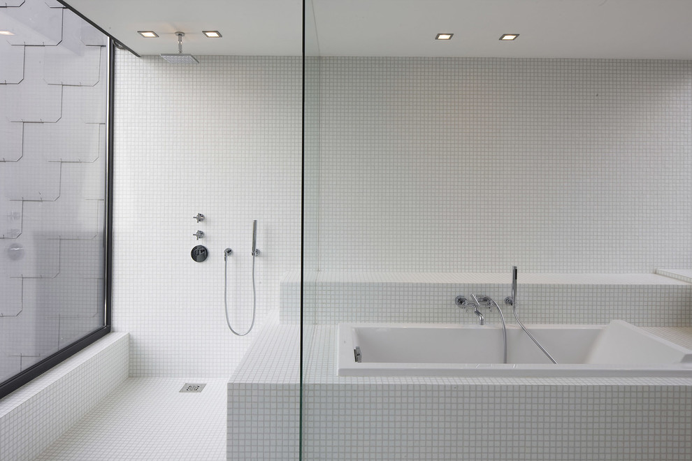 This is an example of a mid-sized contemporary master bathroom in Lille with an open shower, white tile, mosaic tile, mosaic tile floors, white walls, a drop-in tub and an open shower.